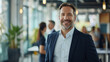 © Farnaces - Portrait of a handsome smiling businessman boss standing in his modern business company office.