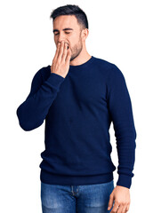 Canvas Print - Young handsome man wearing casual clothes bored yawning tired covering mouth with hand. restless and sleepiness.