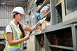 © offsuperphoto - factory worker holding a clipboard and looking at shelf in warehouse storage