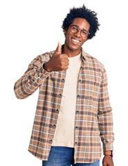 Poster - Handsome african american man with afro hair wearing casual clothes and glasses doing happy thumbs up gesture with hand. approving expression looking at the camera showing success.