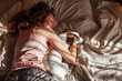 © Tatyana Gladskih - Young woman sleeping with dog on bed