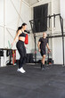 Fitness couple jumping on skipping rope in the gym