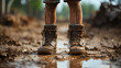 Poor child's muddy feet in the mud close-up, poverty concept