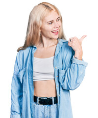 Sticker - Young caucasian woman wearing casual clothes pointing thumb up to the side smiling happy with open mouth