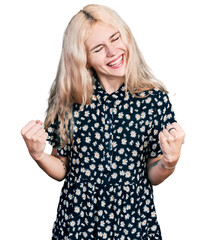 Wall Mural - Young caucasian woman together very happy and excited doing winner gesture with arms raised, smiling and screaming for success. celebration concept.