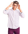 © Krakenimages.com - Young handsome man wearing business clothes and glasses trying to open eyes with fingers, sleepy and tired for morning fatigue