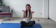 © chokniti - A Sporty young woman enjoy doing morning exercise alone in living room, beautiful Asian female wearing sportswear doing weight training or practicing muscles workout at home for healthy body wellness.