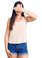 Sticker - Young beautiful caucasian woman wearing casual clothes and glasses smiling and laughing with hand on face covering eyes for surprise. blind concept.