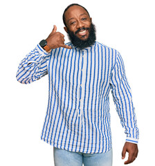 Poster - Young african american man wearing business shirt smiling doing phone gesture with hand and fingers like talking on the telephone. communicating concepts.