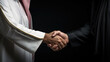 Close up of arab  male and caucasian man in suit shaking hands and close deal