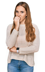 Canvas Print - Young blonde woman wearing casual clothes looking stressed and nervous with hands on mouth biting nails. anxiety problem.