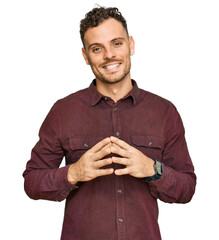 Poster - Young hispanic man wearing casual clothes hands together and fingers crossed smiling relaxed and cheerful. success and optimistic