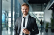 © AI_images_for_people - A handsome businessman with phone in the office.