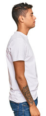 Wall Mural - Young handsome african american man wearing casual white tshirt looking to side, relax profile pose with natural face with confident smile.