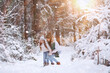 © alexkich - Young family for a walk. Mom and daughter are walking in a winter park.