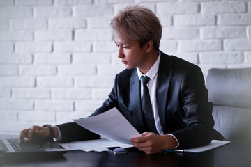 Wall Mural - Young Asian businessman in white shirt and tie