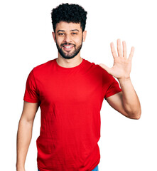 Wall Mural - Young arab man with beard wearing casual red t shirt showing and pointing up with fingers number five while smiling confident and happy.