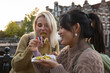 © ReeldealHD images - Female tourists eating local food in Amsterdam