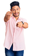 Sticker - Handsome latin american young man wearing casual summer shirt pointing to you and the camera with fingers, smiling positive and cheerful