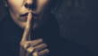 The Silence of Secrecy: A Mysterious Woman Gesturing for Silence with a Finger to Her Lips