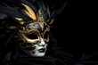 venetian carnival mask in blue gold color palette isolated on black background copy space right. Carnival festival in Venice celebrated in February.