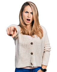 Wall Mural - Young blonde woman wearing casual clothes pointing displeased and frustrated to the camera, angry and furious with you