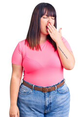 Poster - Young plus size woman wearing casual clothes bored yawning tired covering mouth with hand. restless and sleepiness.