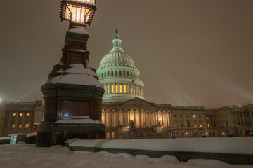 Wall Mural - Snowfall in DC. Winter in American Capitol Washington D.C. Capitol building at night evening winter. U.S. Capitol in snow historical photos. Winter Capitol Hill in Washington D.C.