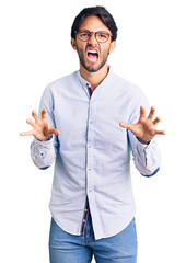 Poster - Handsome hispanic man wearing business shirt and glasses smiling funny doing claw gesture as cat, aggressive and sexy expression