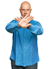 Wall Mural - Middle age bald man wearing casual clothes rejection expression crossing arms and palms doing negative sign, angry face