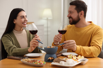 Sticker - Affectionate couple enjoying chocolate fondue during romantic date at home