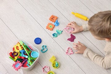 Canvas Print - Cute little boy playing on warm floor indoors, above view. Heating system