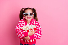 Photo Of Positive Cute Adorable Girl Wear Trendy Clothes Hug Basket Popcorn Cartoon Movie Empty Space Isolated On Pink Color Background
