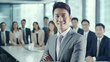 © S photographer - A young Asian businessman is posing confidently in a conference room.