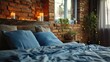 Bed with blue pillow and coverlet near the fireplace. design of modern bedroom with brick wall 