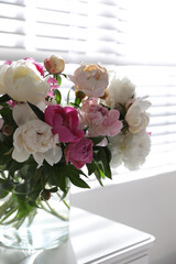 Canvas Print - Beautiful peonies in vase on table near window indoors