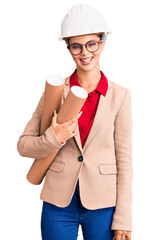 Sticker - Young beautiful woman wearing architect hardhat and glasses holding blueprints looking positive and happy standing and smiling with a confident smile showing teeth