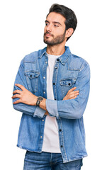 Poster - Young hispanic man wearing casual clothes looking to the side with arms crossed convinced and confident