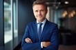 © kimly - Happy middle aged business man ceo standing in office arms crossed. Smiling mature confident professional executive manager, proud lawyer,