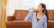 © Art_Photo - Portrait sport beauty body slim woman drinking water from a bottle while relax and feeling fresh, refresh drink, wellness, healthcare, mineral at home.Healthy liquid lifestyle concept