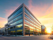 Modern office building with glass facade at sunset. Business and industrial concept.