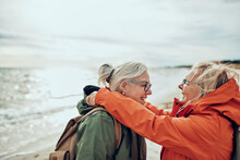 Two happy elderly women enjoying a day at the beach