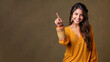© pariketan - Happy indian woman pointing her finger at copy space for promotion