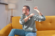 © astrosystem - Man with shoulder pain at home.