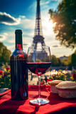 Fototapeta  - a bottle of wine and a glass of wine on a table with a tower in the background