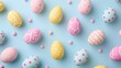 Patterned easter eggs on a blue backdrop accented with pink candy beads, creating a whimsical holiday scene