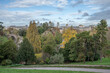 Paris, France - 11 11 2023: Park des Buttes Chaumont. View the central part of the park with footbridge, belvedere island, Temple of the Sibyl and the lake under construction due to renovation.