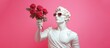 White sculpture of Apollo with a bouquet of red roses on a pink background. Banner.