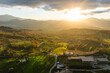 © AmazingAerialAgency - Aerial view of a mountains and hills landscape with vineyard and countryside houses at sunset in autumn colours, Irpinia, Avellino, Campania, Italy.