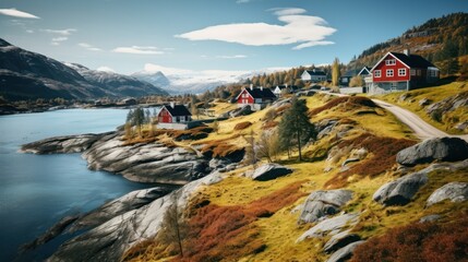 Poster -  a group of houses sitting on the side of a mountain next to a body of water with mountains in the background.